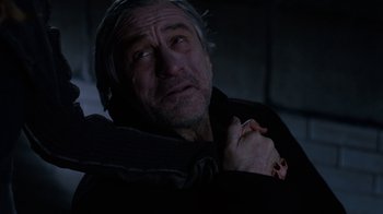Movie still from “New Year's Eve” (2011), directed by Garry Marshall – An older man is holding his hands over his chest; Close Up shot, High angle