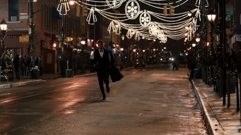 Movie still from “New Year's Eve” (2011), directed by Garry Marshall – A man walking down a street at night; Extreme Wide shot, Low angle