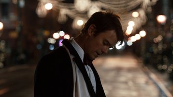 Movie still from “New Year's Eve” (2011), directed by Garry Marshall – A man in a suit and tie standing in the street; Close Up shot, Low angle