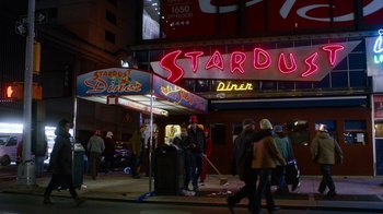 Movie still from “New Year's Eve” (2011), directed by Garry Marshall – A group of people standing outside of a diner; Wide shot, High angle