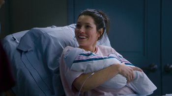Movie still from “New Year's Eve” (2011), directed by Garry Marshall – A woman sitting in a hospital bed holding a pillow; Close Up shot, Overhead angle