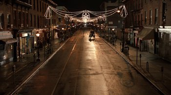 Movie still from “New Year's Eve” (2011), directed by Garry Marshall – An empty street at night with lights hanging from the ceiling; Extreme Wide shot, High angle