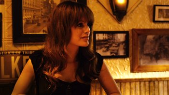 Movie still from “New York, I Love You” (2008), directed by Wen Jiang – A woman with long brown hair sitting at a table; Close Up shot, Over the shoulder angle
