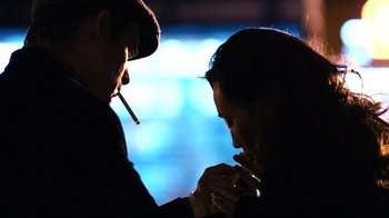 Movie still from “New York, I Love You” (2008), directed by Wen Jiang – A man and a woman are smoking a cigarette together; Close Up shot, Over the shoulder angle