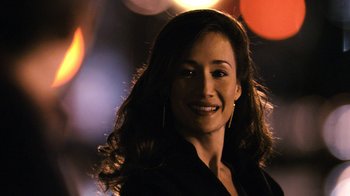 Movie still from “New York, I Love You” (2008), directed by Wen Jiang – A woman with long dark hair smiling for the camera; Close Up shot, Over the shoulder angle
