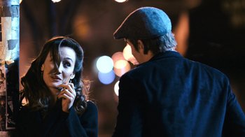 Movie still from “New York, I Love You” (2008), directed by Wen Jiang – A man and a woman standing next to each other on a street; Close Up shot, Over the shoulder angle