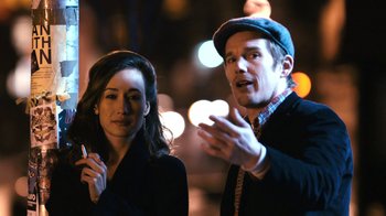 Movie still from “New York, I Love You” (2008), directed by Wen Jiang – A man and a woman standing next to each other on a street; Close Up shot, Over the shoulder angle