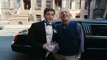 Movie still from “New York, I Love You” (2008), directed by Wen Jiang – A man and a man in a tuxedo holding a glass; Medium shot, Low angle