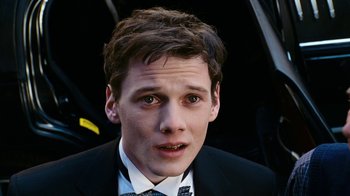 Movie still from “New York, I Love You” (2008), directed by Wen Jiang – A man in a suit and tie looking at the camera; Close Up shot, Over the shoulder angle