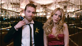 Movie still from “New York, I Love You” (2008), directed by Wen Jiang – A man and a woman posing for a picture; Medium shot, Low angle