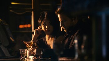 Movie still from “New York, I Love You” (2008), directed by Wen Jiang – A man and a woman sitting at a table with a drink; Medium shot, Over the shoulder angle