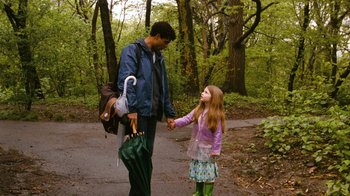 Movie still from “New York, I Love You” (2008), directed by Wen Jiang – A man and a little girl holding hands in the woods; Medium shot, Over the shoulder angle