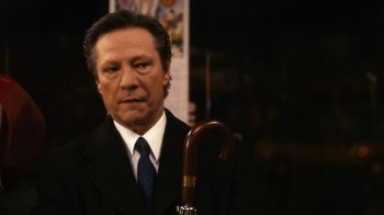 Movie still from “New York, I Love You” (2008), directed by Wen Jiang – A man in a suit and tie holding a cane; Close Up shot, Low angle
