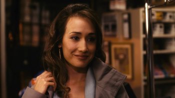 Movie still from “New York, I Love You” (2008), directed by Wen Jiang – A woman with long brown curly hair is smiling; Close Up shot, Over the shoulder angle