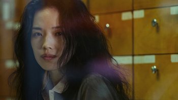 Movie still from “New York, I Love You” (2008), directed by Wen Jiang – A woman with long black hair is looking at the camera; Close Up shot, Over the shoulder angle
