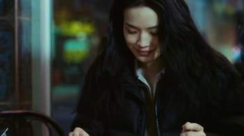 Movie still from “New York, I Love You” (2008), directed by Wen Jiang – A woman with long black hair is smiling; Close Up shot, Over the shoulder angle