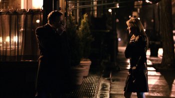 Movie still from “New York, I Love You” (2008), directed by Wen Jiang – A man and a woman standing next to each other on a sidewalk; Medium shot, Over the shoulder angle