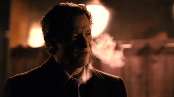 Movie still from “New York, I Love You” (2008), directed by Wen Jiang – A man in a suit and tie is smoking a cigarette; Close Up shot, Low angle
