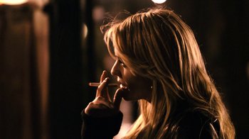 Movie still from “New York, I Love You” (2008), directed by Wen Jiang – A woman is smoking a cigarette in the dark; Close Up shot, Over the shoulder angle