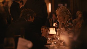 Movie still from “New York, I Love You” (2008), directed by Wen Jiang – Two people sitting at a table with a glass of red wine; Medium shot, Over the shoulder angle