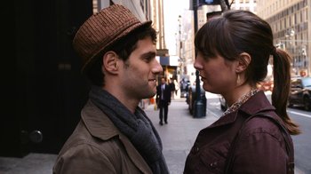Movie still from “New York, I Love You” (2008), directed by Wen Jiang – A man and a woman standing next to each other on the street; Close Up shot, Over the shoulder angle