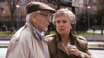 Movie still from “New York, I Love You” (2008), directed by Wen Jiang – An older man standing next to an older woman; Medium shot, Over the shoulder angle
