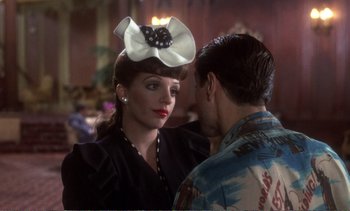 Movie still from “New York, New York” (1977), directed by Martin Scorsese – A woman wearing a black and white hat and a man wearing a hawaiian shirt; Close Up shot, Over the shoulder angle