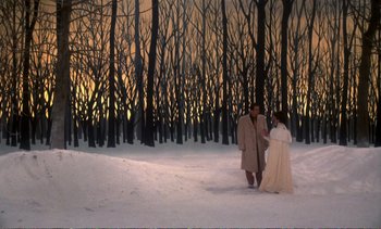 Movie still from “New York, New York” (1977), directed by Martin Scorsese – Two people walking in the snow in front of a forest; Extreme Wide shot, High angle