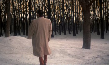 Movie still from “New York, New York” (1977), directed by Martin Scorsese – A man walking in the snow near a group of trees; Wide shot, High angle