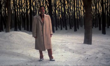 Movie still from “New York, New York” (1977), directed by Martin Scorsese – A man standing in the middle of a snowy forest; Wide shot, Low angle