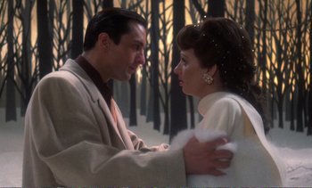 Movie still from “New York, New York” (1977), directed by Martin Scorsese – A man and a woman standing next to each other in front of trees; Close Up shot, Low angle