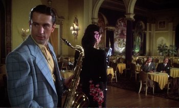 Movie still from “New York, New York” (1977), directed by Martin Scorsese – A man and a woman playing a saxophone in a restaurant; Medium shot, Low angle