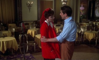 Movie still from “New York, New York” (1977), directed by Martin Scorsese – A man and a woman standing next to each other in a restaurant; Medium shot, Over the shoulder angle