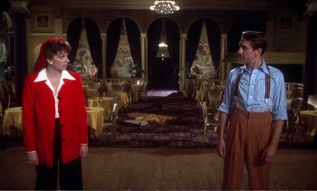 Movie still from “New York, New York” (1977), directed by Martin Scorsese – A man and a woman standing in front of each other in a room; Wide shot, Low angle