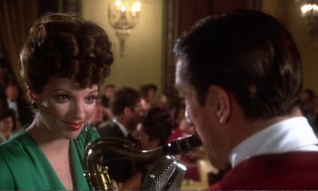 Movie still from “New York, New York” (1977), directed by Martin Scorsese – A man and a woman with a saxophone in a room; Close Up shot, Over the shoulder angle