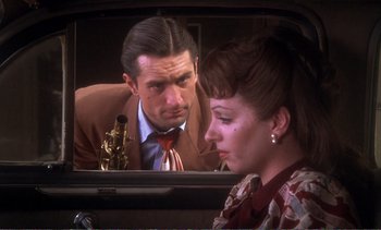 Movie still from “New York, New York” (1977), directed by Martin Scorsese – A man and a woman looking in a car mirror; Close Up shot, Over the shoulder angle