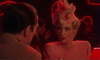 Movie still from “New York, New York” (1977), directed by Martin Scorsese – A woman wearing a pink hat and a pink dress; Close Up shot, Over the shoulder angle