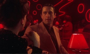 Movie still from “New York, New York” (1977), directed by Martin Scorsese – A man and a woman are sitting at a table in a restaurant; Medium shot, Over the shoulder angle