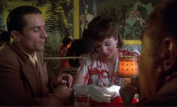 Movie still from “New York, New York” (1977), directed by Martin Scorsese – A man and a woman sitting at a table in a restaurant; Medium shot, Over the shoulder angle