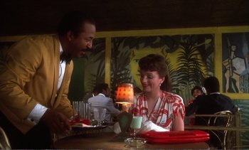 Movie still from “New York, New York” (1977), directed by Martin Scorsese – A man and a woman are sitting at a table; Medium shot, Over the shoulder angle