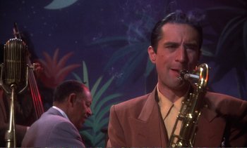 Movie still from “New York, New York” (1977), directed by Martin Scorsese – A man smoking a cigarette while holding a saxophone; Close Up shot, Low angle
