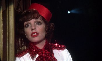 Movie still from “New York, New York” (1977), directed by Martin Scorsese – A person wearing a red hat; Close Up shot, Low angle