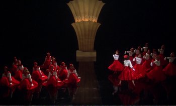 Movie still from “New York, New York” (1977), directed by Martin Scorsese – A group of people dressed in red are performing a dance; Extreme Wide shot, High angle