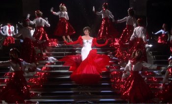 Movie still from “New York, New York” (1977), directed by Martin Scorsese – A group of women dressed in red and white dancing on steps; Wide shot, Overhead angle