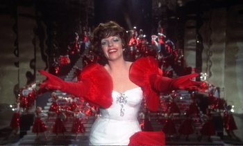 Movie still from “New York, New York” (1977), directed by Martin Scorsese – A woman in a white dress and red gloves; Medium shot, Low angle