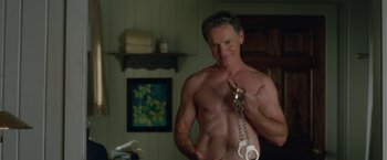 Movie still from “Gerald's Game” (2017), directed by Mike Flanagan – A man holding a pair of handcuffs in a bathroom; Medium shot, High angle
