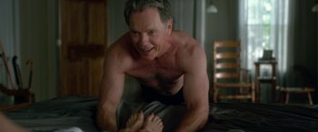 Movie still from “Gerald's Game” (2017), directed by Mike Flanagan – A man laying on a bed with his bare feet on the ground; Medium shot, High angle