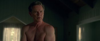Movie still from “Gerald's Game” (2017), directed by Mike Flanagan – A shirtless man with no shirt looking at the camera; Close Up shot, Over the shoulder angle