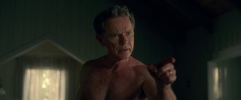 Movie still from “Gerald's Game” (2017), directed by Mike Flanagan – An older man with no shirt is holding something in his hand; Close Up shot, Over the shoulder angle