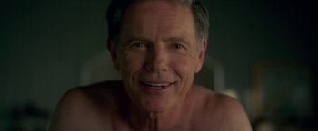 Movie still from “Gerald's Game” (2017), directed by Mike Flanagan – A man smiling for the camera; Close Up shot, Over the shoulder angle